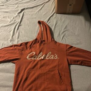 Cabela’s sweatshirt 
Size: S 
Color: Rust